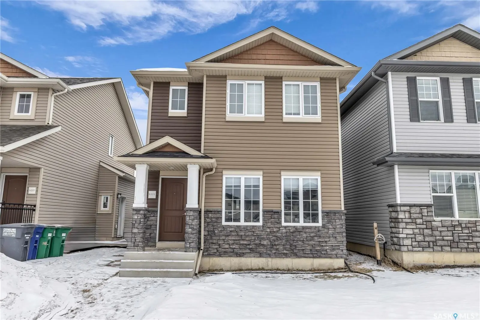 Modern 4-bed, 4-bath home in Rosewood, Saskatoon, with a legal suite, heated garage, and prime location near shops & dining.